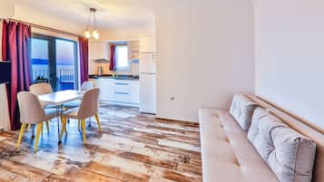 Superior Apartment, Sea View | Living area | 80-cm flat-screen TV with satellite channels, LCD TV