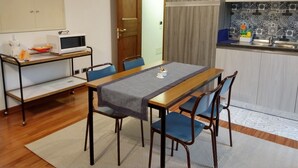 A compact kitchen with a microwave, sink, and patterned backsplash. - B&B Il Torchio (Urbino)