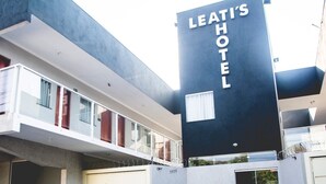 Leati's Hotel with a modern design, featuring a prominent black sign with white lettering.