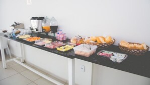 A buffet setup with various food items and beverages.