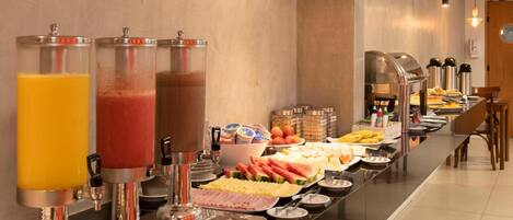 A buffet with various food items and beverages.