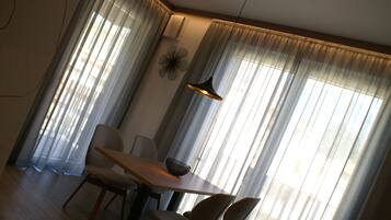 Panoramic Apartment (Orchidea) | Living area | 32-inch TV with cable channels, heated floors