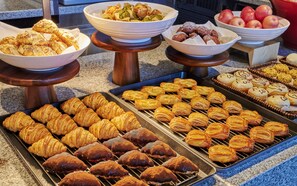 A variety of baked goods displayed on trays and in bowls, including pastries and cookies. - Hyatt Regency Shenzhen Yantian (Shenzhen)