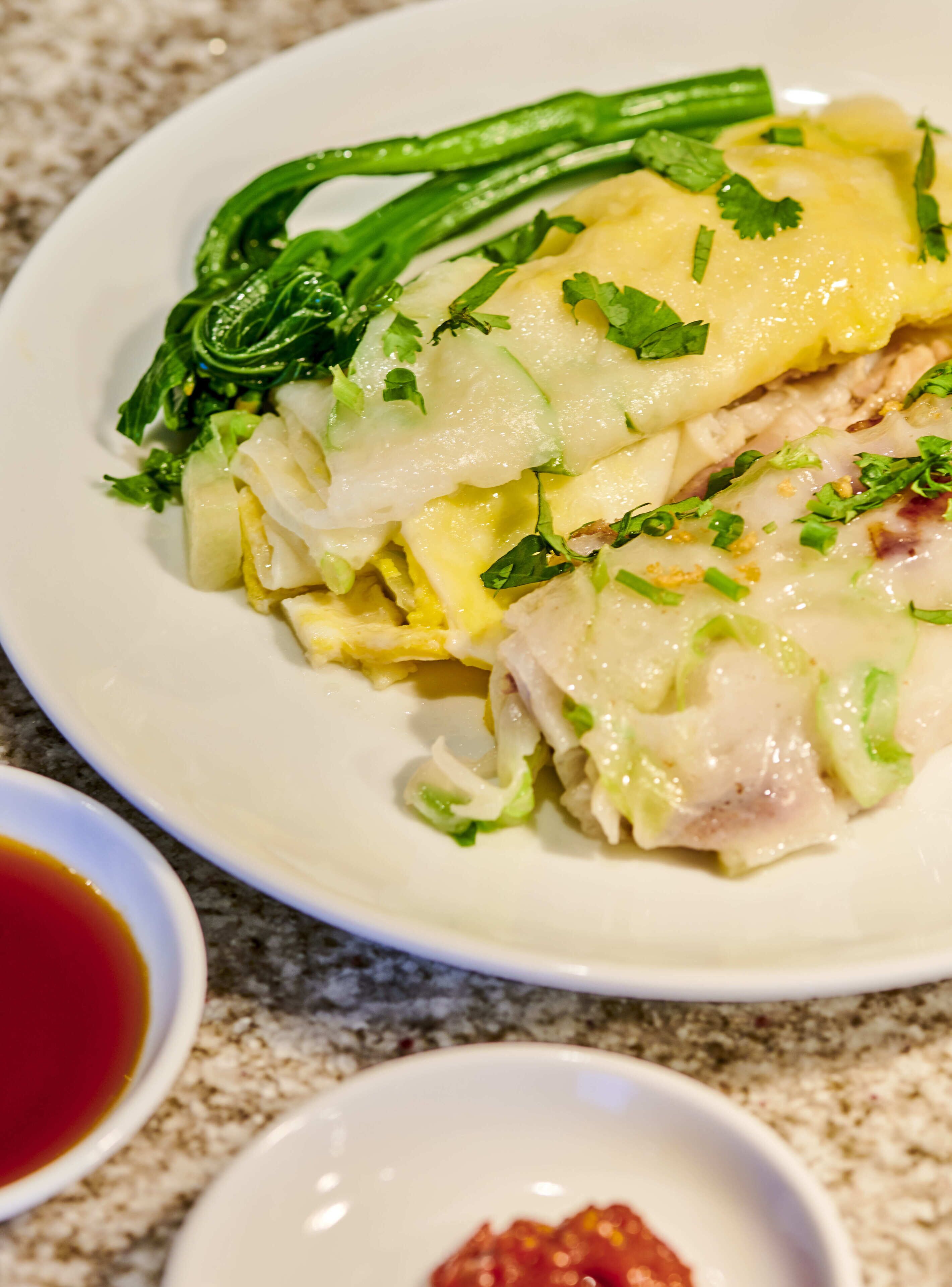 A plate of food with green vegetables and a sauce.