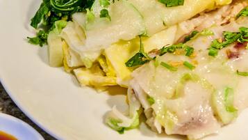 A plate of food with green vegetables and a sauce.
