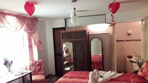 A hotel room with a bed, a desk, a chair, a wardrobe, and a mirror. - Hotel El Eden de Adan y Eva (Andahuaylas)