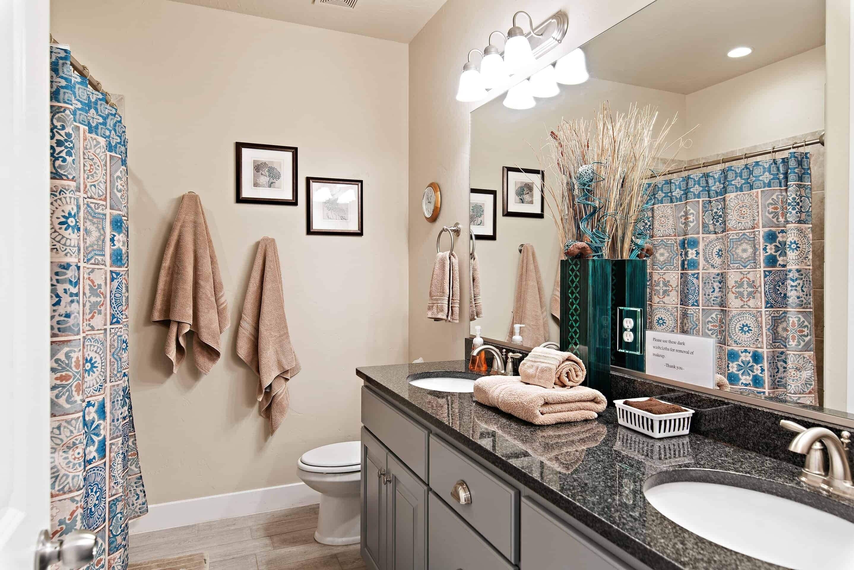 A bathroom with a sink, mirror, and towel rack.