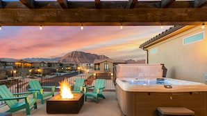 A patio with outdoor seating, a fire feature, and a hot tub. - Paintbrush Retreat #65 by RedAwning (Ivins)