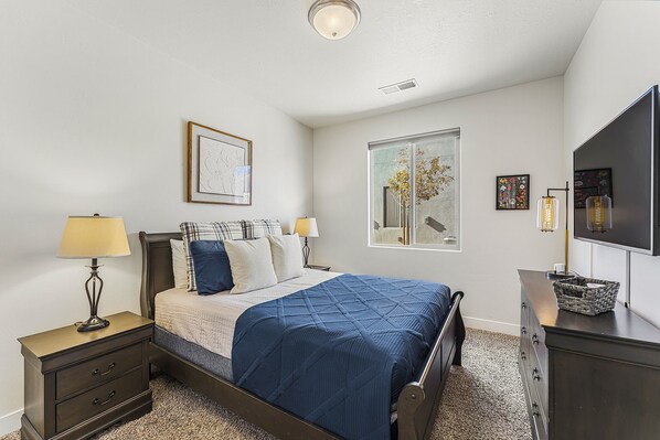 A bedroom with a bed, nightstands, a dresser, a television, and artwork on the walls. - Mountain View by RedAwning (Washington)