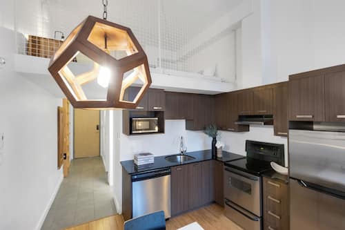 Premium Apartment, 1 Bedroom, City View, Mezzanine (The Main 306) | Living area | 49-inch flat-screen TV with digital channels, Smart TV, offices
