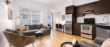 Premium Apartment, Multiple Beds, City View, Mezzanine (The Main 201) | Living area | 49-inch flat-screen TV with digital channels, Smart TV, offices