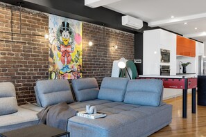 Superior Penthouse, Multiple Beds, 2 Bathrooms, City View (with Loft Plaza 300) | Living area | 65-inch Smart TV with digital channels, TV, fireplace -  Liv MTL - Plaza (Montreal)