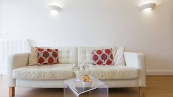 Apartamento (2 Bedrooms) | Sala de estar | Una televisión LED, un reproductor de DVD, libros, una videoteca