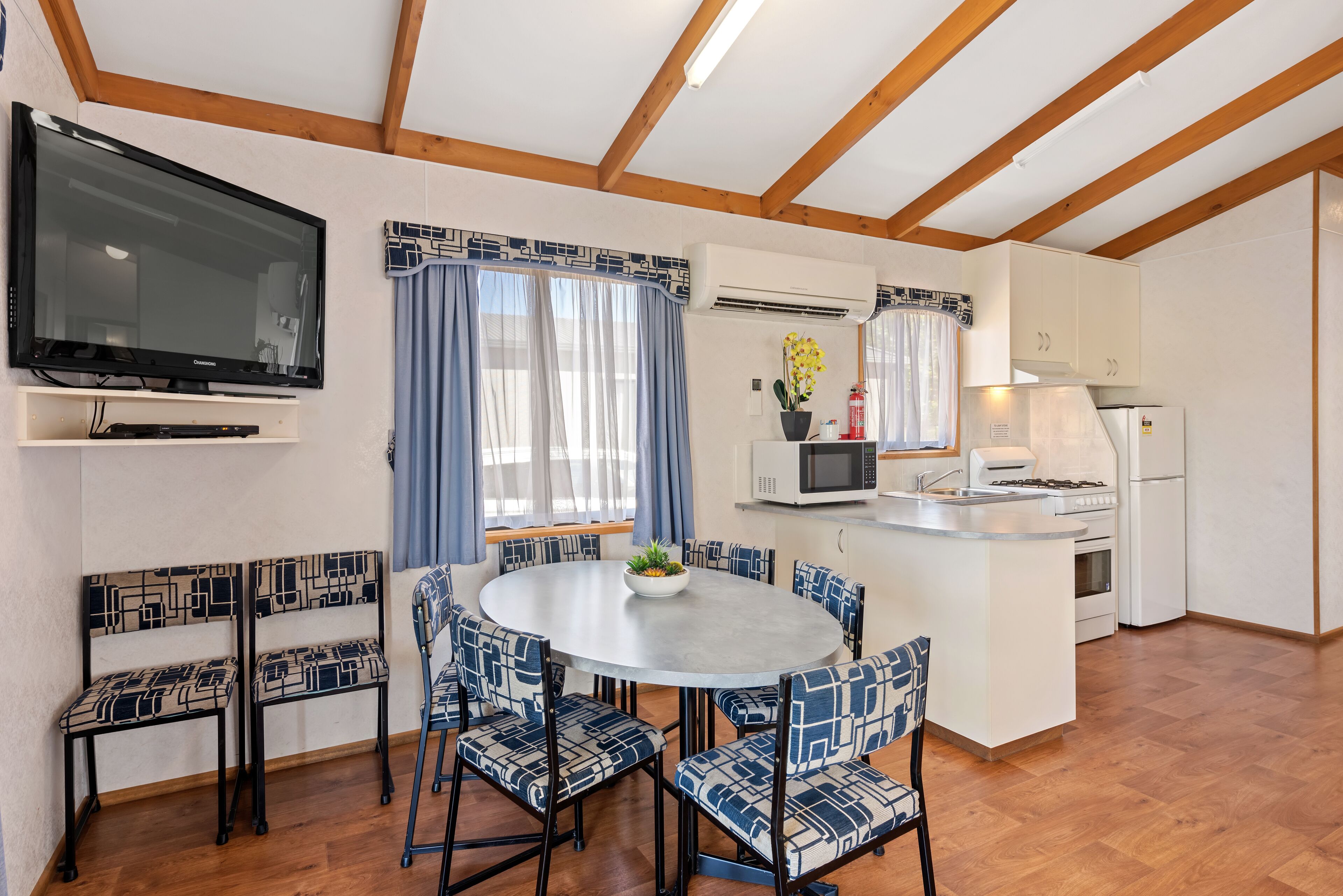 A compact kitchen with a microwave, stove, and refrigerator.