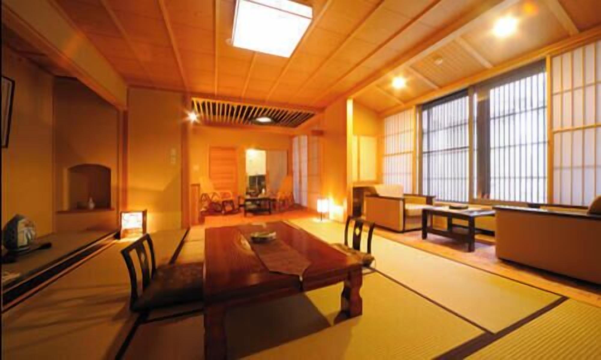 A traditional Japanese-style room with tatami flooring, a low table, and sliding doors.