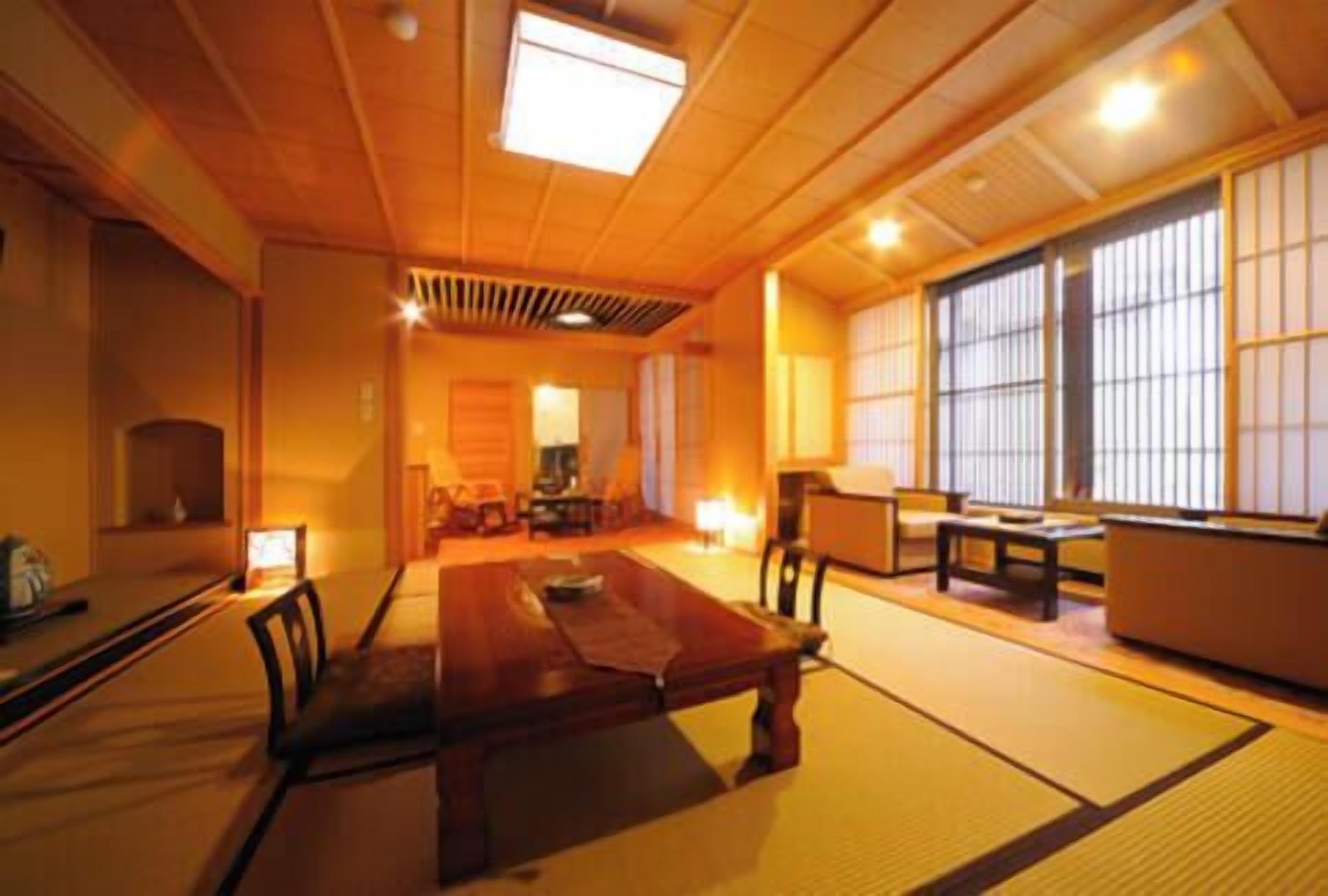A traditional Japanese room with tatami flooring, a low table, and sliding doors.