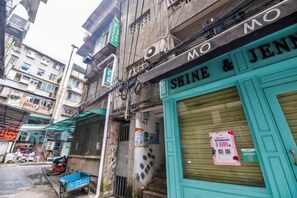 A narrow street with closed shops, including one with a shuttered window and a sign that reads 'SHINE & JEN'. - I am waiting for you in Guilin Youth Hostel (Liangjiang Sihu East-West Alley) (Guilin)