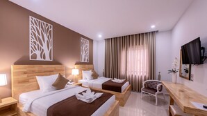 A hotel room with two beds, a desk, a chair, a TV, and a large window with curtains. - Double S Hotel (Battambang)