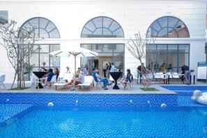 Outdoor pool, open 6:00 AM to midnight, pool umbrellas, pool loungers