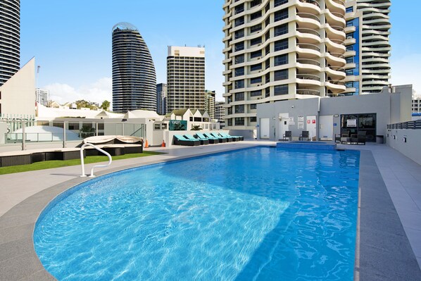 Outdoor pool, pool loungers - Victoria Square 2 Bed Ocean View (Broadbeach)