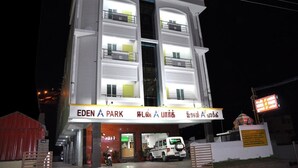 A multi-story building with a sign reading "EDEN A PARK" and Tamil script. - Eden A Park (Palani)