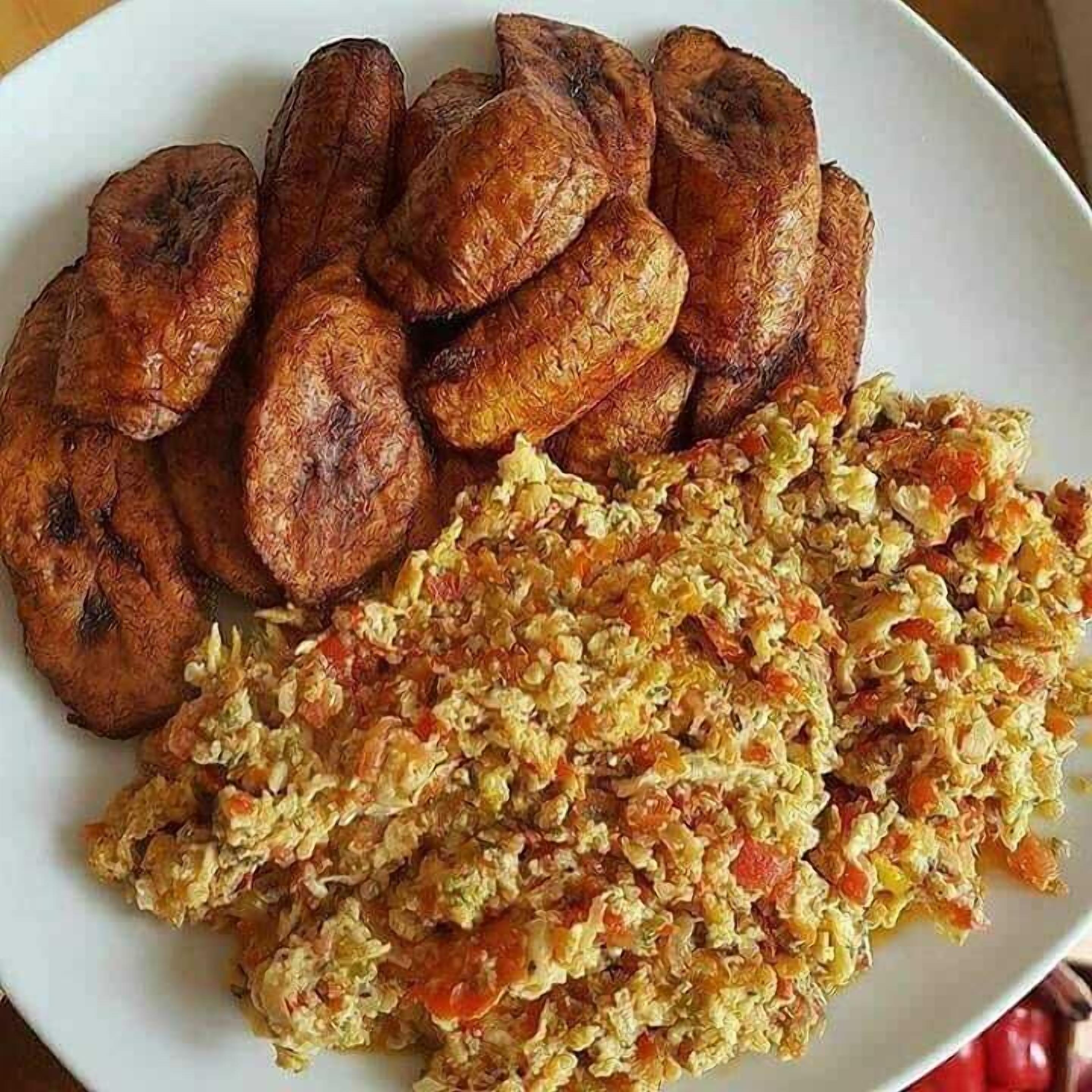 A plate with fried plantains and a mixed vegetable dish.