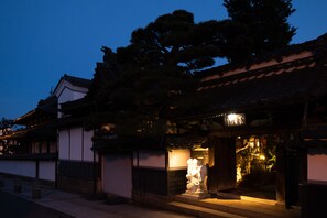 A traditional building with a tiled roof and a statue outside. - Zenkoji Temple Yakuoin (Nagano)