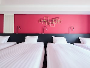 A hotel room with two beds, a red accent wall, and modern wall art. - HOTEL GEOMETIQ Osaka Umeda, an Ascend Collection Hotel (Osaka)