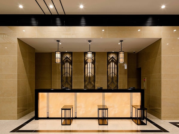 A reception area with a reception desk, three pendant lights, and a reception sign. - HOTEL GEOMETIQ Osaka Umeda, an Ascend Collection Hotel (Osaka)
