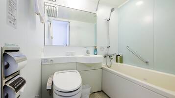 Un baño moderno con inodoro, lavamanos y bañera.