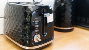 A modern toaster with a textured surface and control buttons. - Spencer House (Leeds)