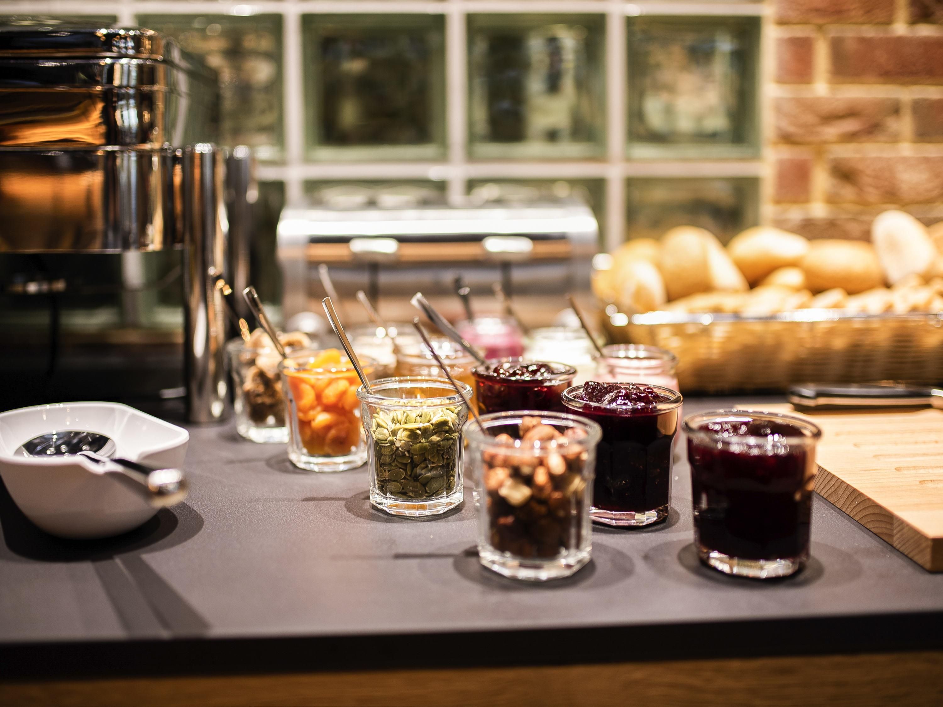 A buffet with various food items and a coffee machine.