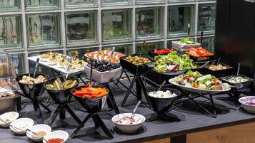 A buffet with various food items and condiments.
