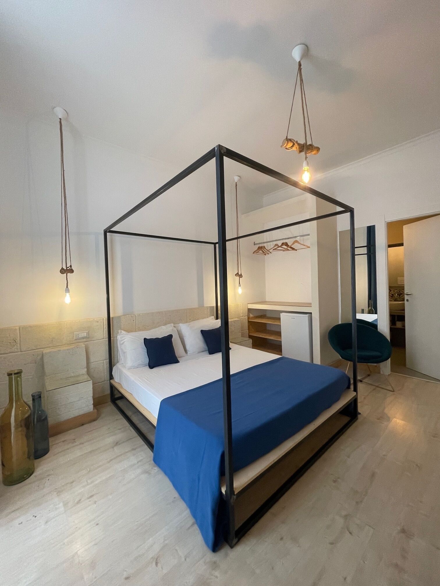 Ein modernes Schlafzimmer mit einem Himmelbett, einem Schreibtisch und einem Stuhl.