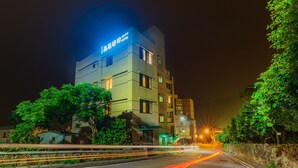 A multi-story hotel with a sign indicating it is the "MAYU HOTEL". - Mayu Hotel (Nangan)