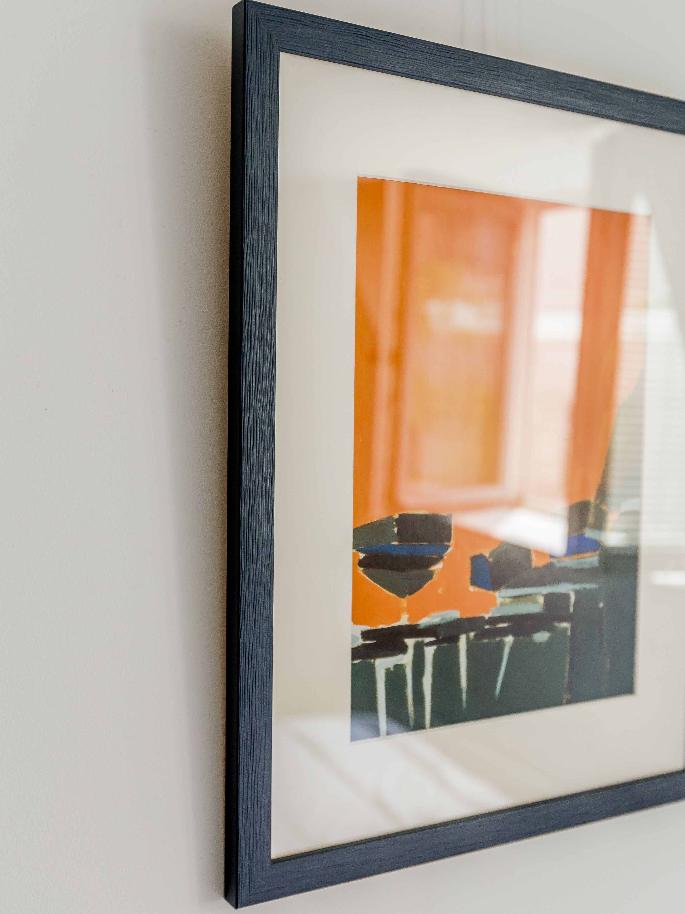 A framed artwork on a wall.