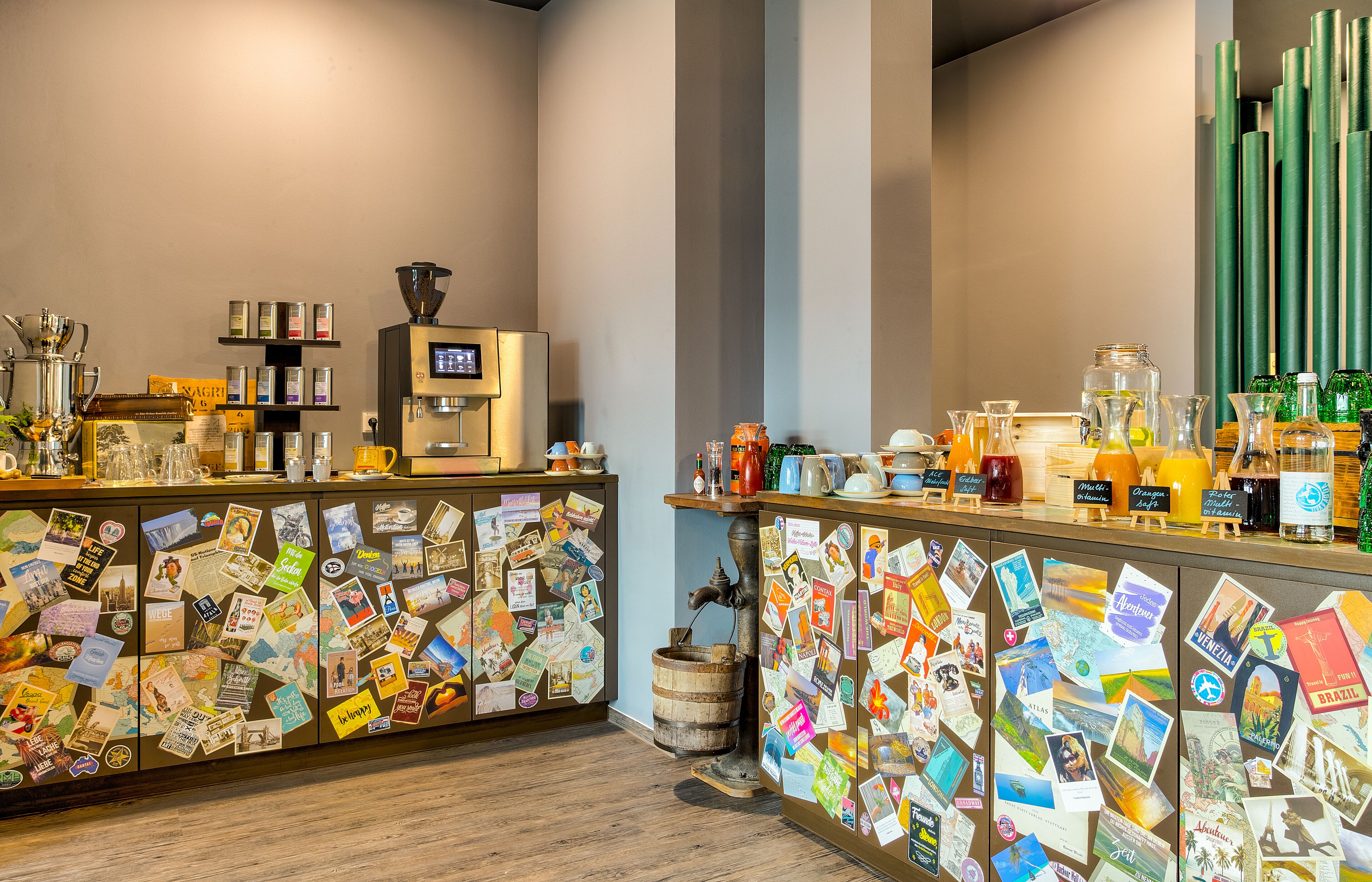 Un comptoir de café avec une machine à café, des étagères remplies de produits à base de café et un mur décoré de photos de voyage.