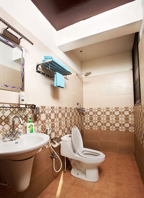 A bathroom with a sink, toilet, and shower.