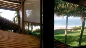 Une pièce dotée d’un toit de chaume et offrant une vue sur la plage.