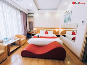 A hotel room with a bed, a desk, a chair, a sofa, and a mirror. - Reddoorz Home Hotel Truong Cong Giai (Hanoi)