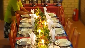 A long dining table set with plates, glasses, and a centerpiece with candles. - Atta Rainforest Lodge (Mauisparu)