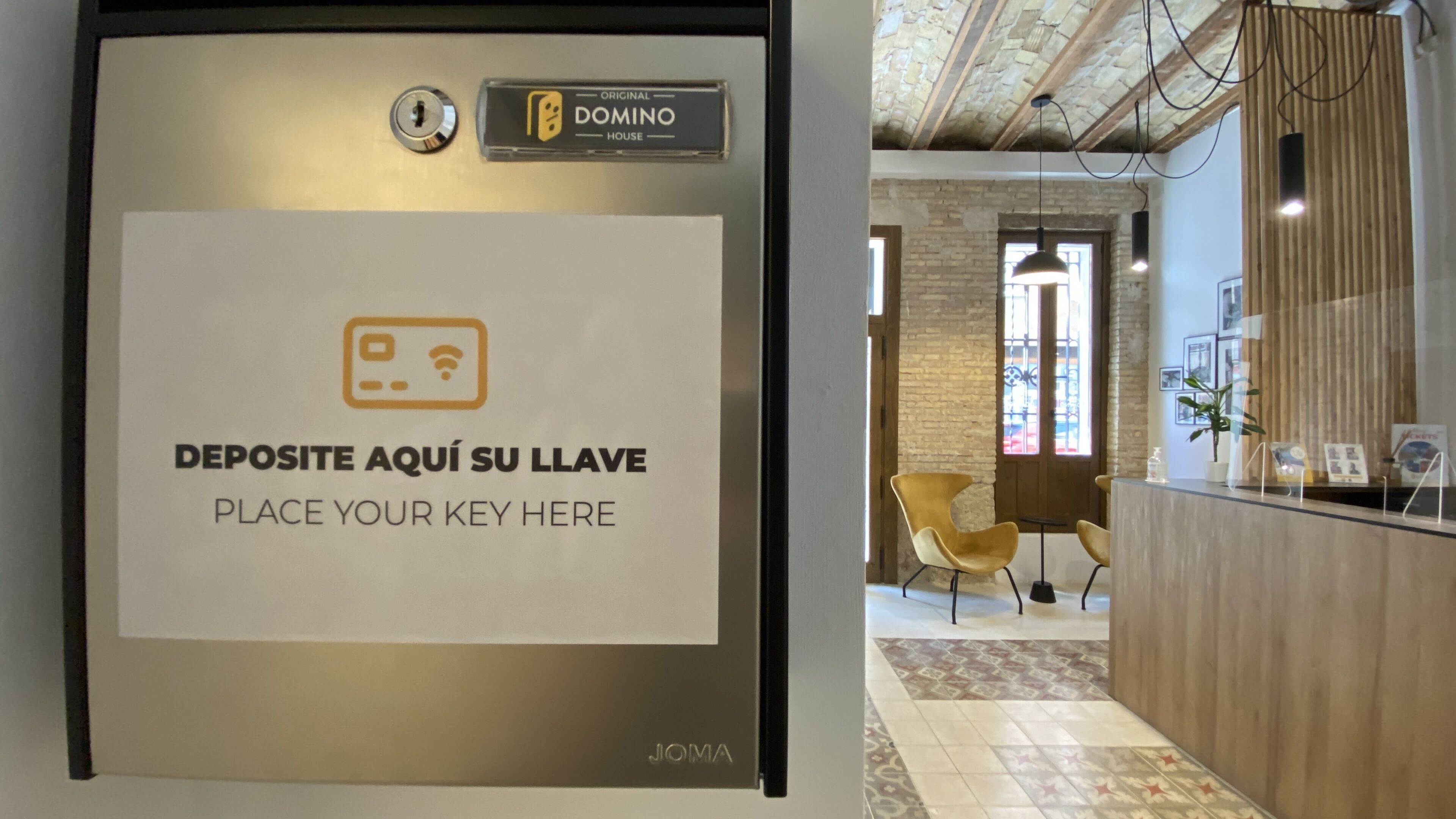 A reception desk with a sign instructing to deposit keys.