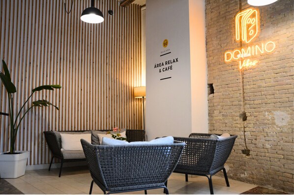 Un interior moderno con mobiliario de mimbre, un letrero de neón y un revestimiento de pared de madera vertical.