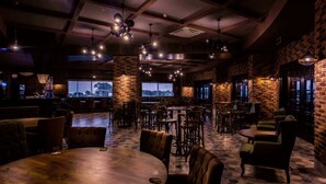 A cozy restaurant with brick walls, wooden tables, and hanging lights. - Eftalia Ocean Resort and Spa (Alanya)