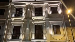 A multi-story building with balconies and windows, illuminated by street lighting. - Elite Accommodations & Hydromassage Pool (Reggio Calabria)