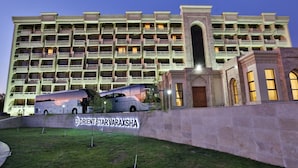 A multi-story hotel with a prominent entrance and a sign reading "ORIENT STAR VARAXSHA". - Orient Star Varaxsha (Bukhara)