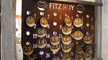 A wooden wall calendar with numbered dates, Fitzroy logo, and a rock display below.