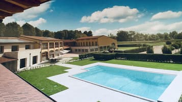 Seasonal outdoor pool, open 10:00 AM to 7:00 PM, pool umbrellas