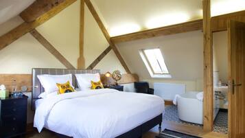 A bedroom with a large bed, a nightstand, a globe lamp, and a window.