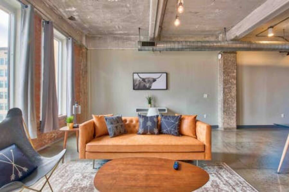 A modern living room with a sofa, a coffee table, and a framed picture on the wall.